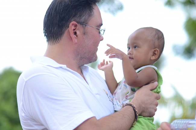 Micheal with one of the children moving into the house he sponsored